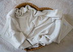 100% RWS-certified merino wool baby blanket. Soft, breathable, and naturally temperature-regulating, this sustainable knit is gentle on delicate skin and perfect for year-round use. The timeless design with subtle pointelle details makes it an heirloom-quality piece – ideal for cuddles, sleep, or as a thoughtful baby shower gift.
